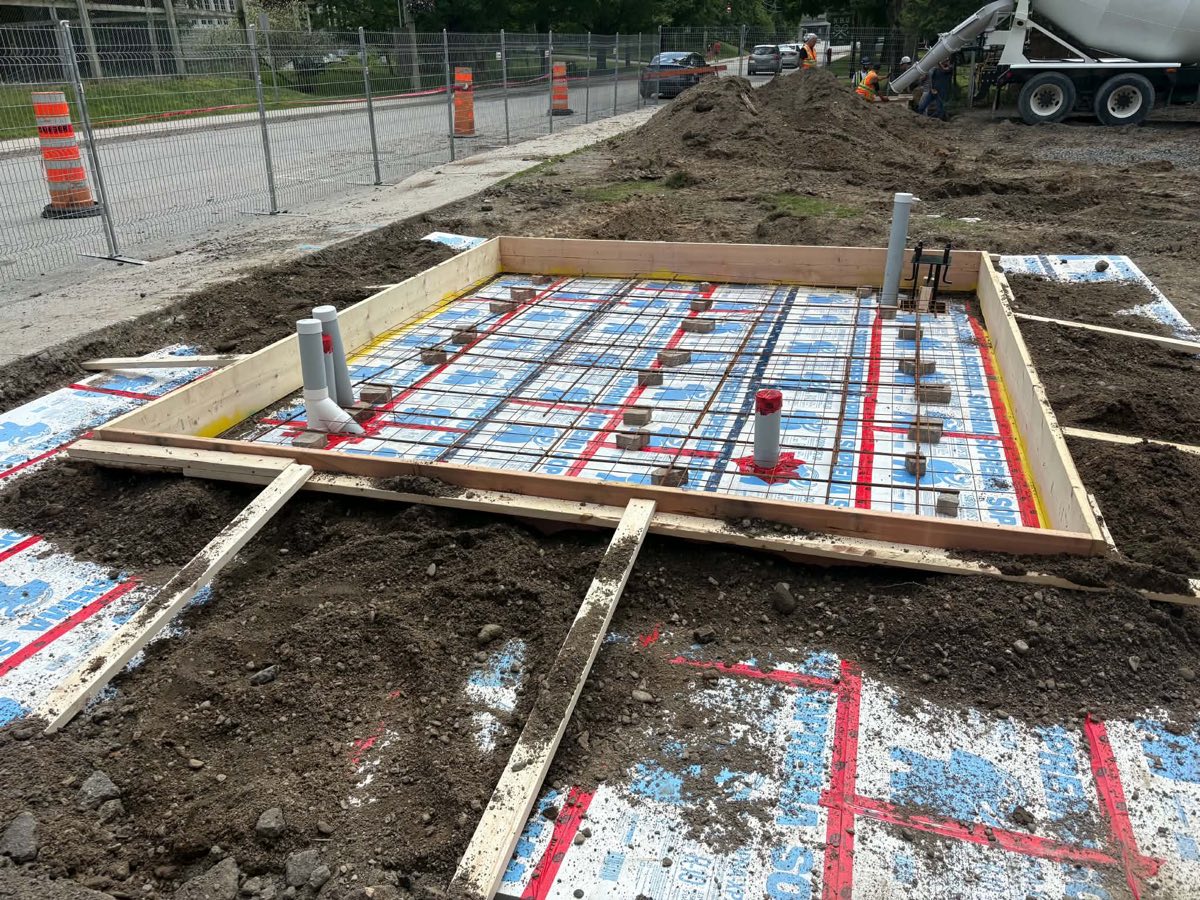 Reinforcement and conduit entries prepared before pouring a concrete equipment base