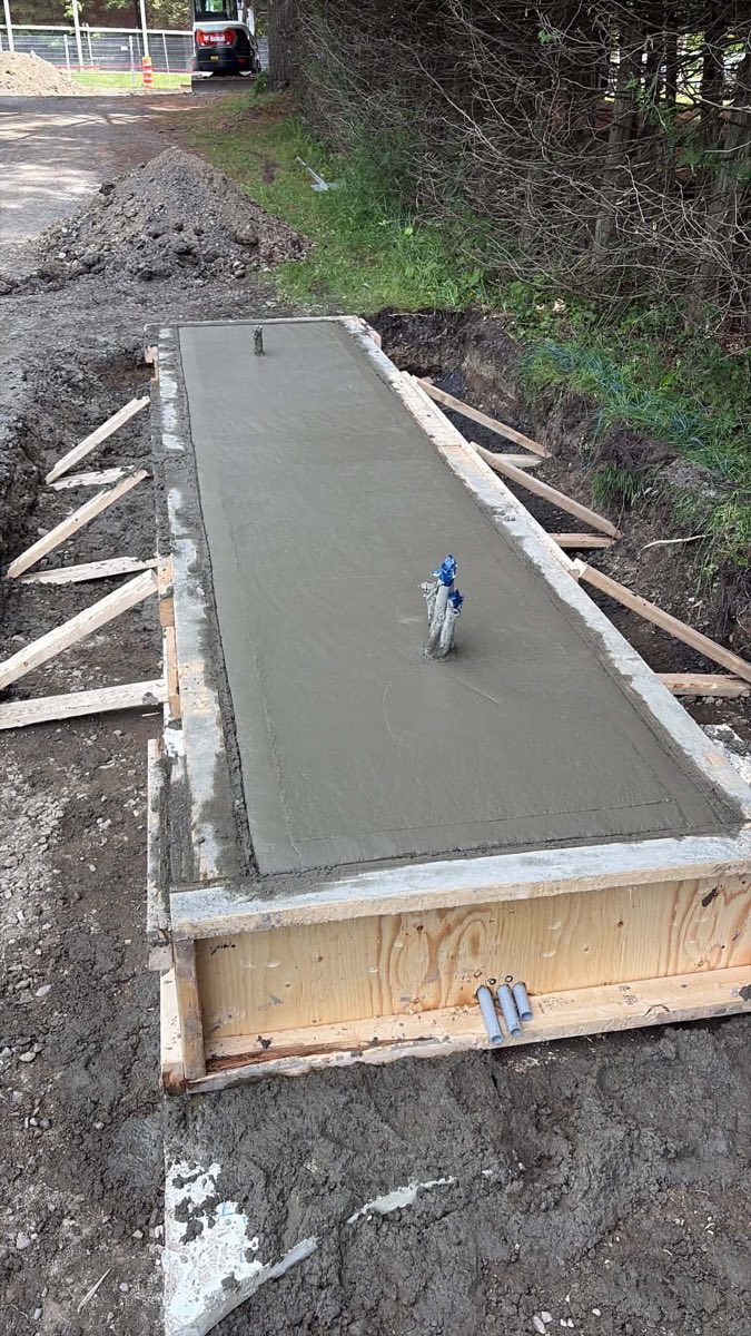 New concrete slab with protected conduits for access control equipment