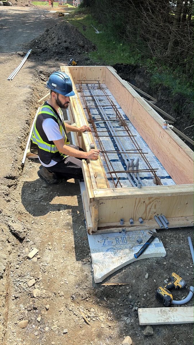 Lexoh field worker preparing conduits and formwork for an access control equipment base