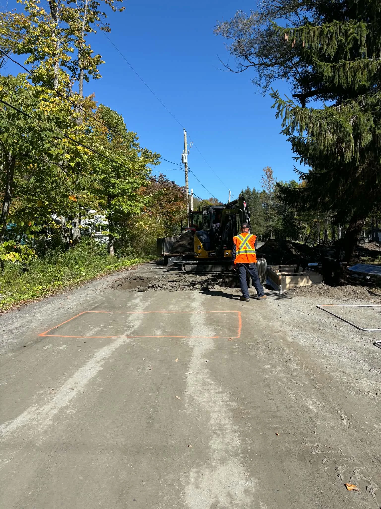 Field crew excavating an access lane and preparing an equipment base