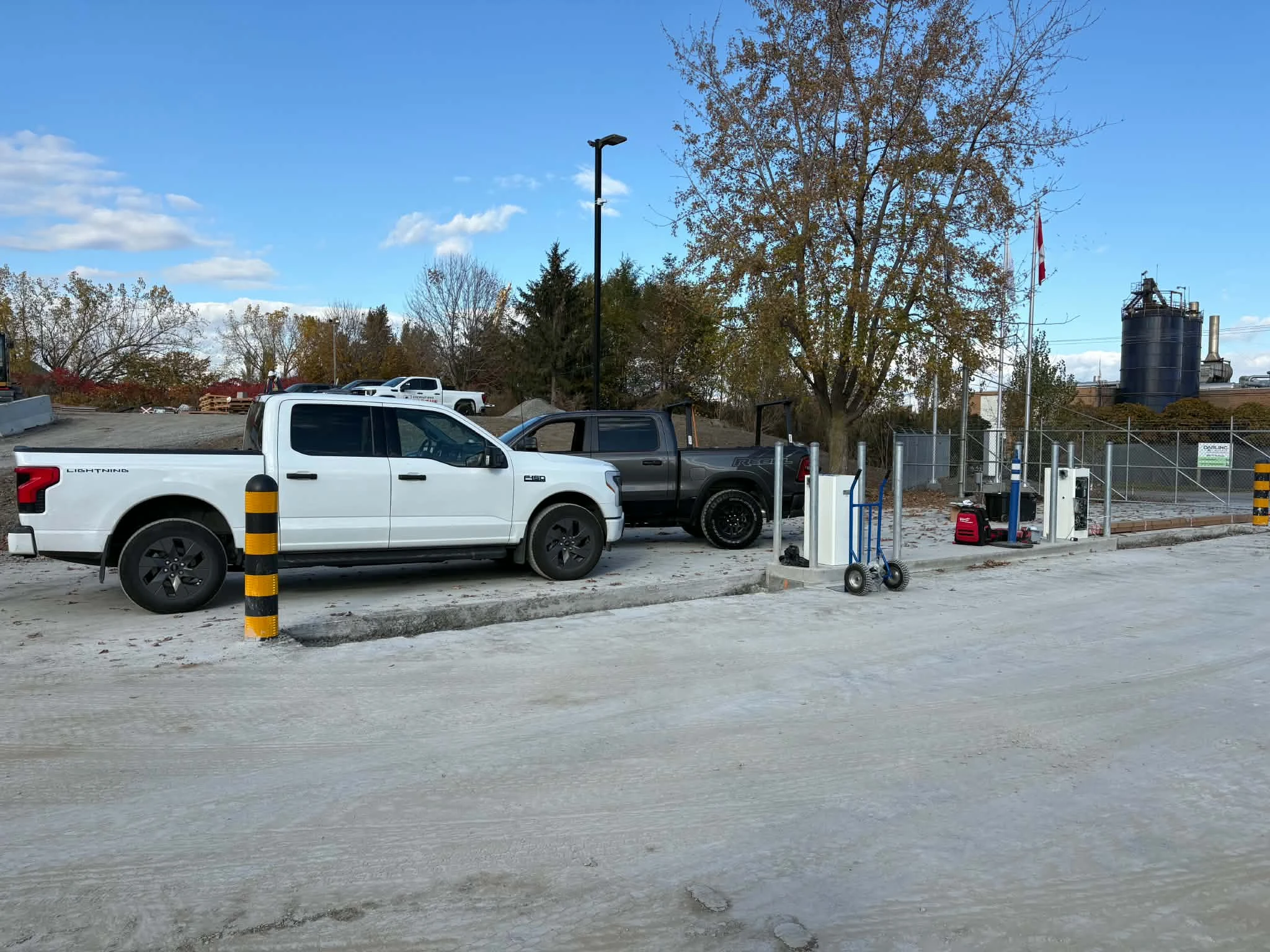 Open control enclosures, protective posts and installation tools along the concrete island at CertainTeed.